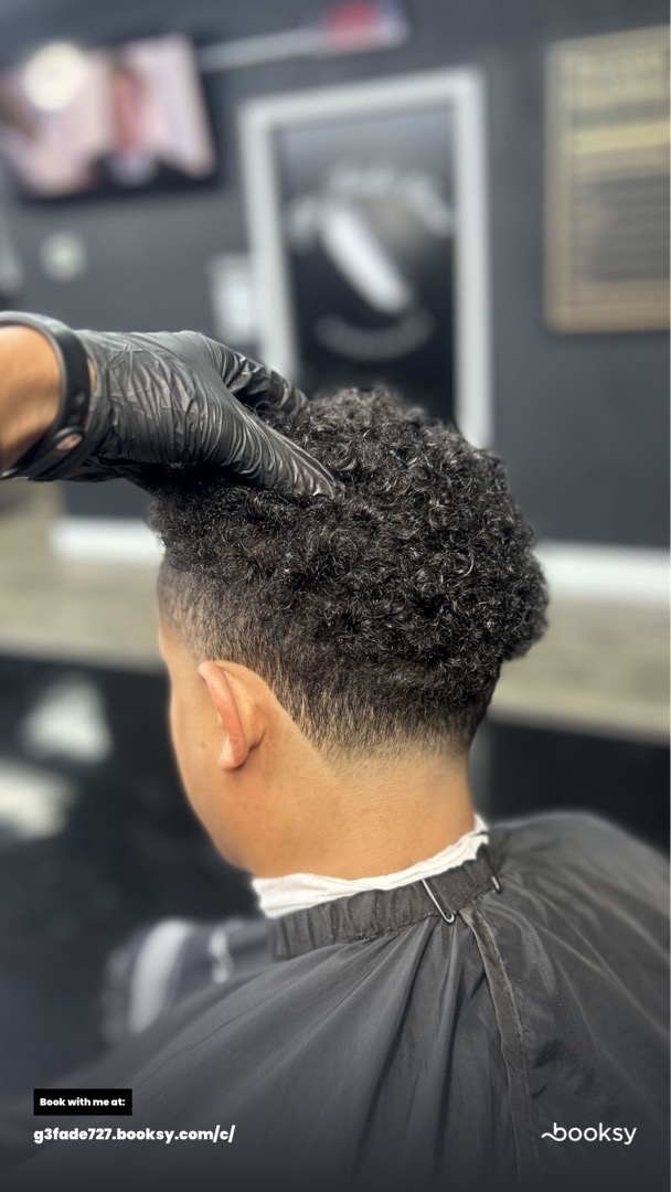 Curly taper fade haircut by The Blend Lab